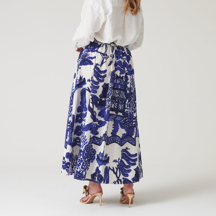 person wearing an a-line skirt with blue Japanese style design on a white background