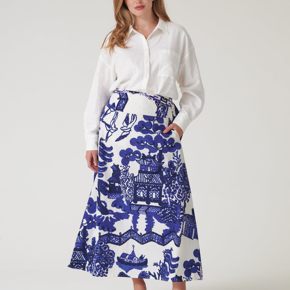 person wearing an a-line skirt with blue Japanese style design on a white background