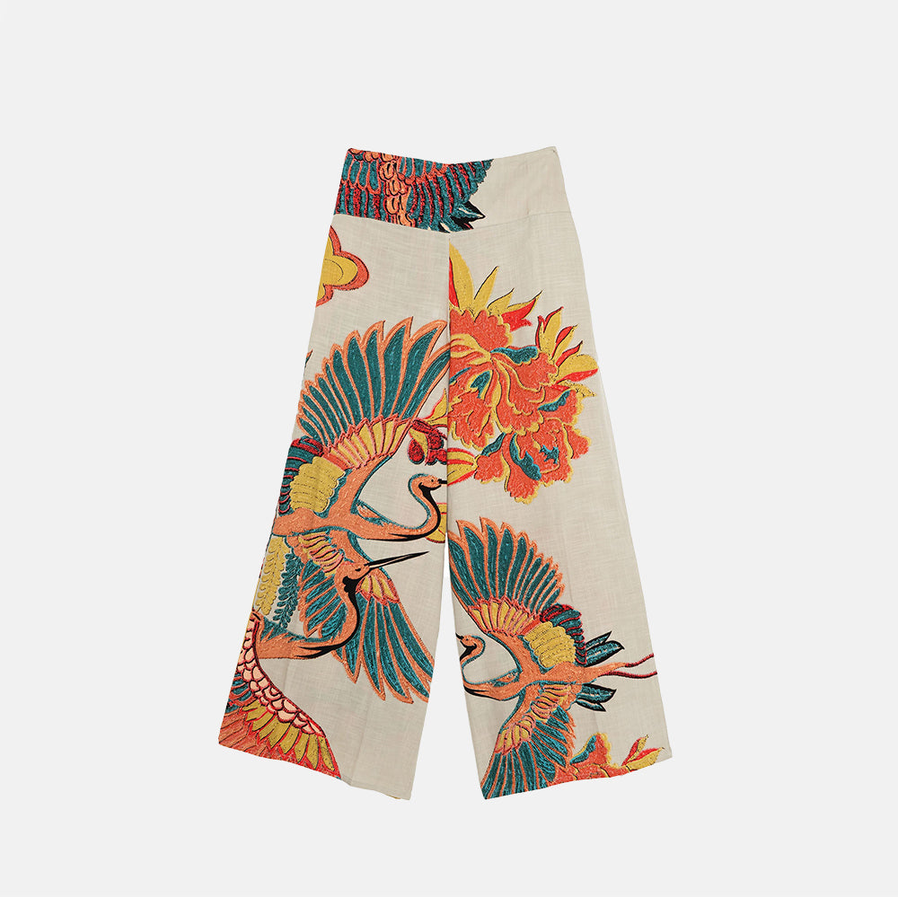 Colourful cranes & floral patterned palazzo pants on a white background