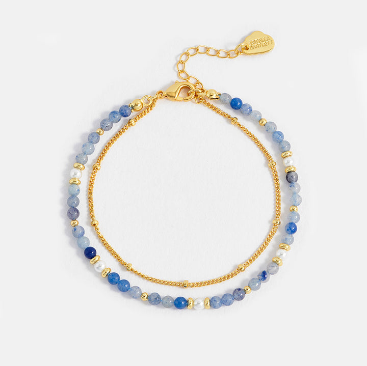 Two beaded bracelets with gold chain on a white background