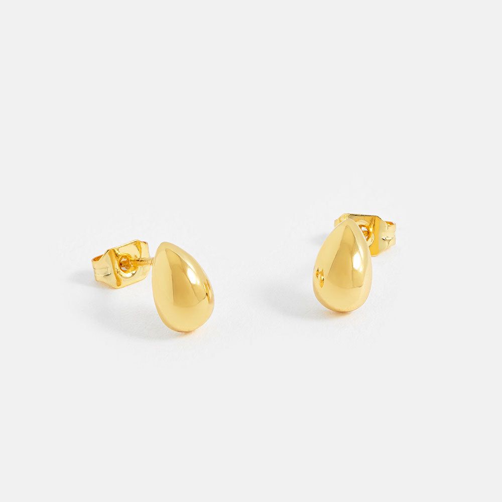 Gold teardrop-shaped earrings on a white background