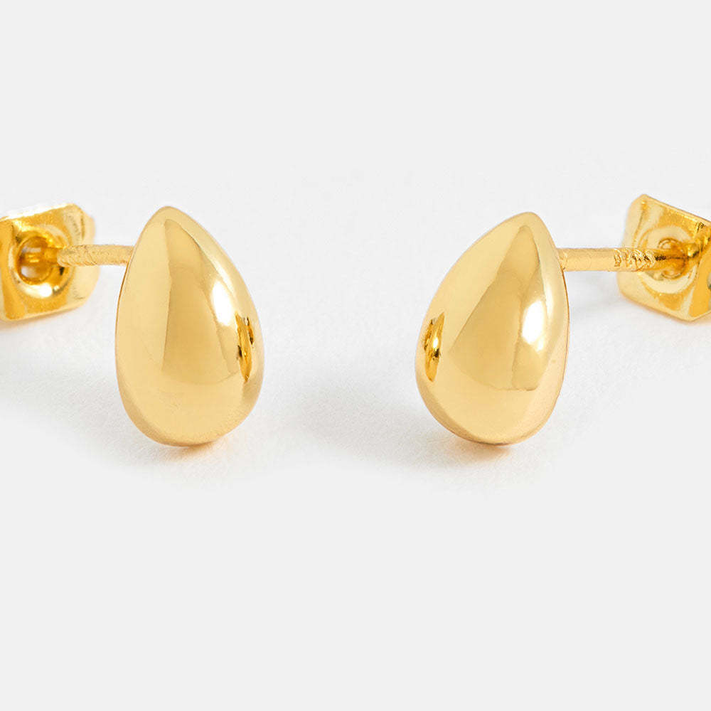 Gold teardrop earrings on a white background