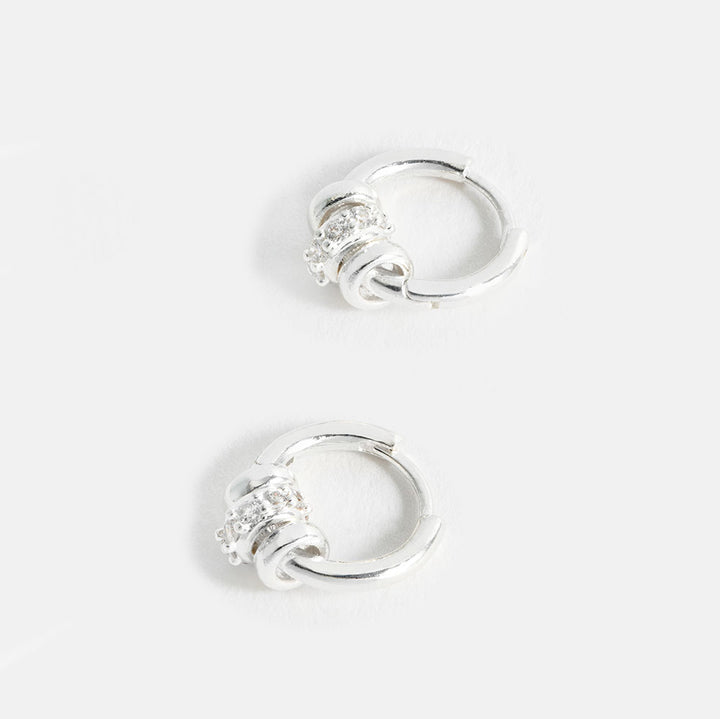silver plated huggie hoop earrings with 3 silver discs, one with cubic zirconia