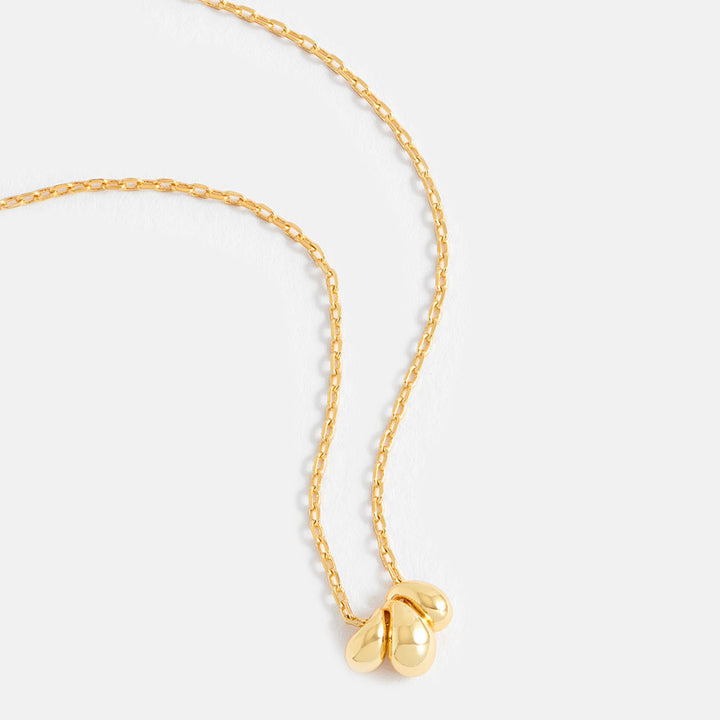 gold fine chain necklace with three gold teardrop shaped beads