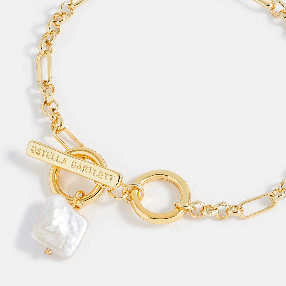 gold bracelet with t-bar clasp and square pearl pendant