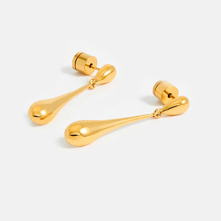 Pair of gold teardrop earrings on a white background