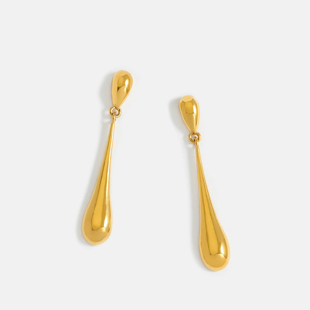 Pair of gold teardrop earrings on a white background