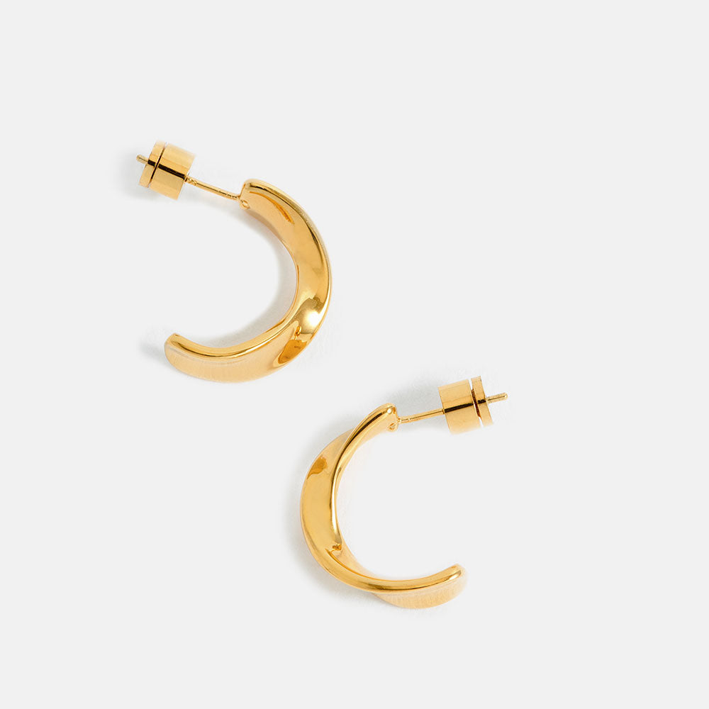 Gold twist hoop earrings on a white background