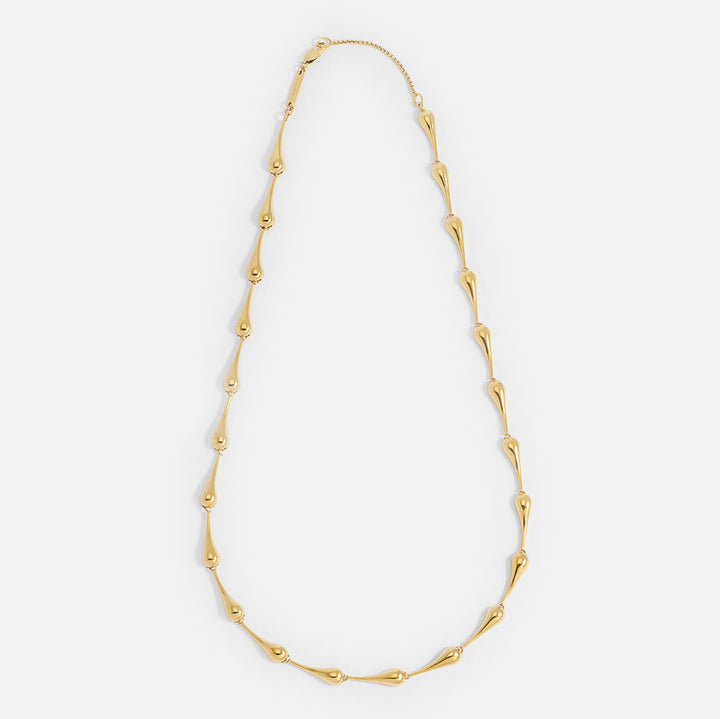 gold teardrop link necklace on a light grey background