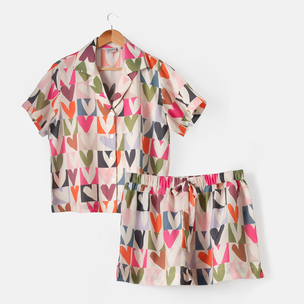 Colorful heart-patterned pajama set on a white background
