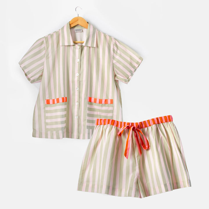 Striped pyjama shirt and shorts set on a white background