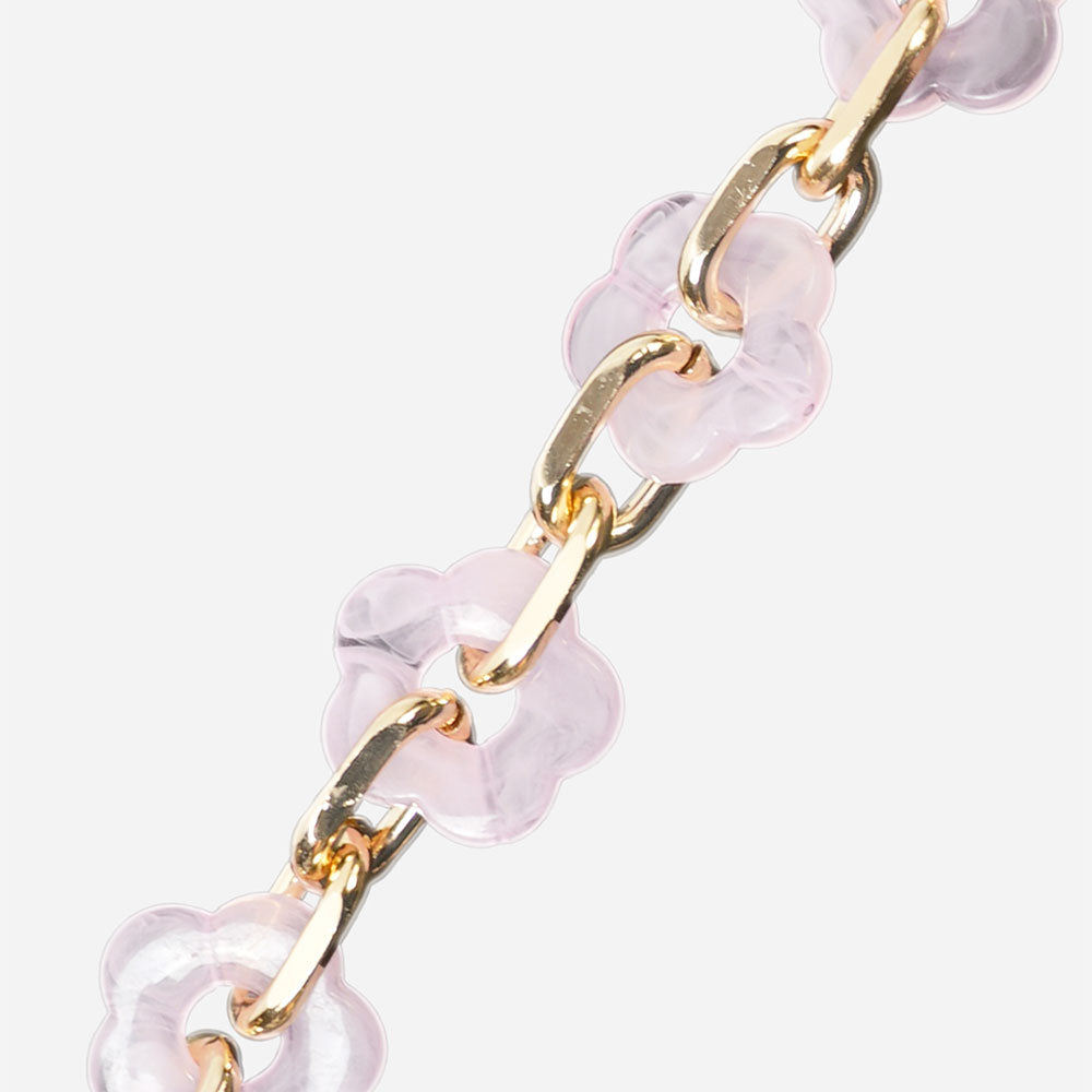 Gold chain bracelet with pink flower beads on a white background