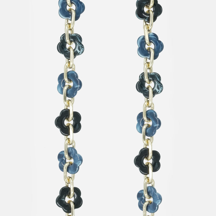 phone chain with blue and black floral beads on a white background
