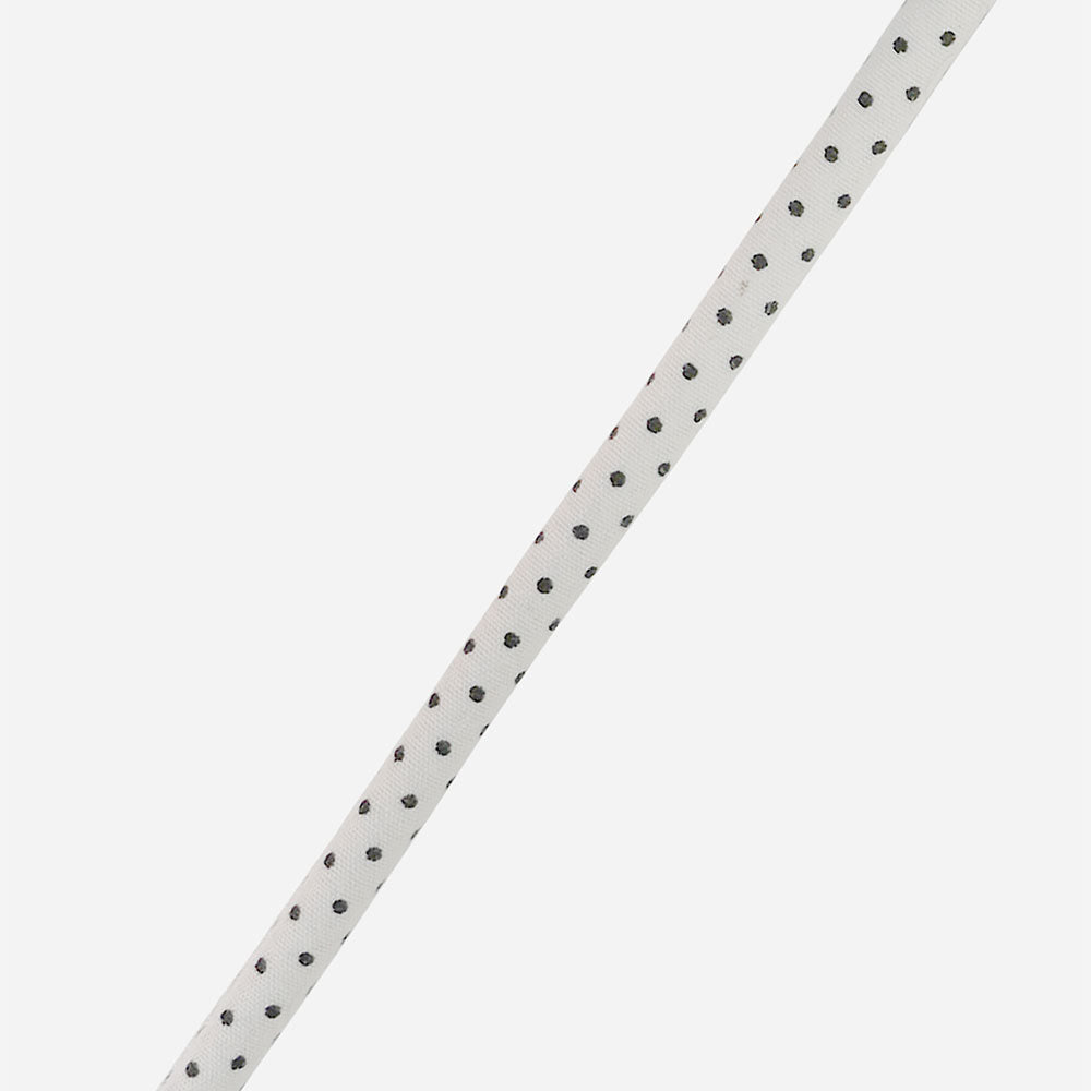 white & black polka dot vegan leather phone cord on a light grey background