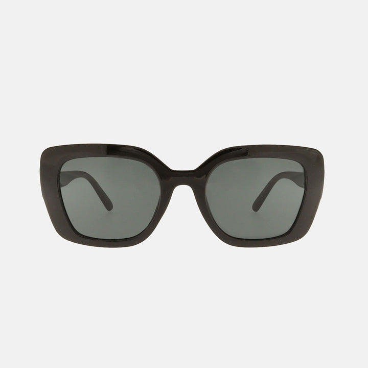 Black sunglasses with dark lenses on a light gray background