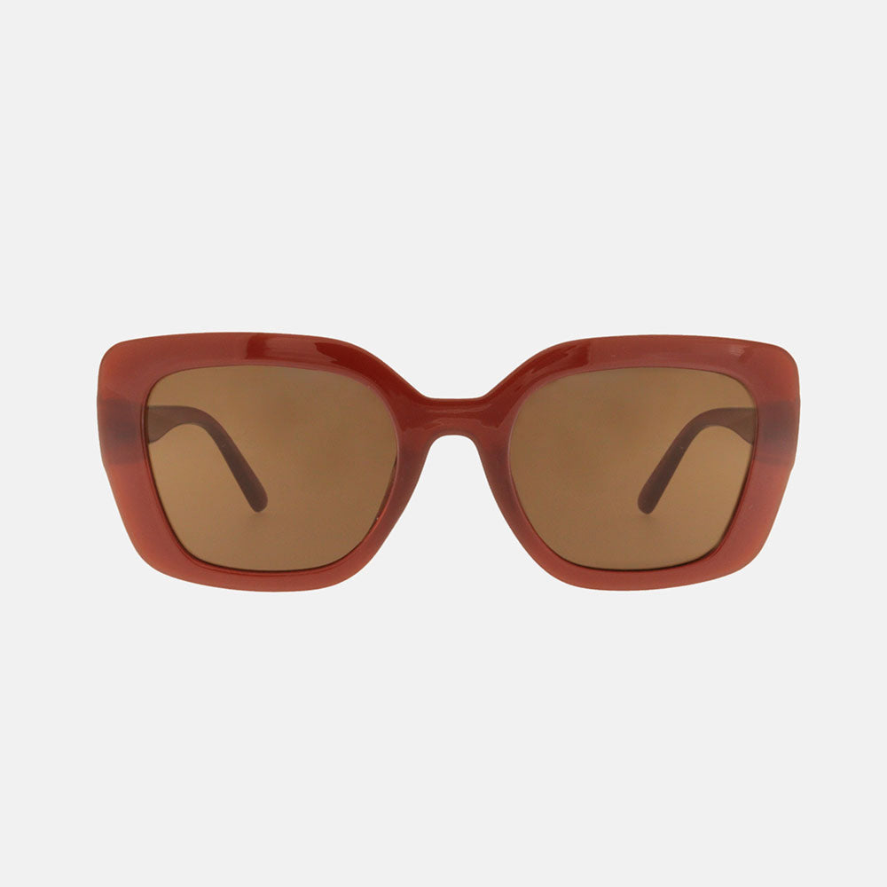 Red sunglasses with brown lenses on a white background