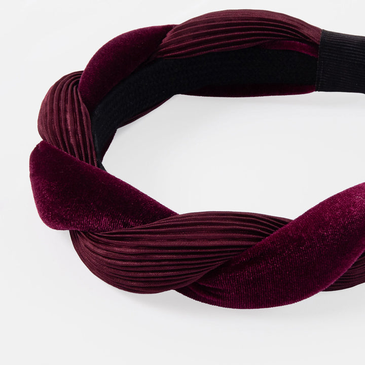 Maroon pleated twist headband on a white background