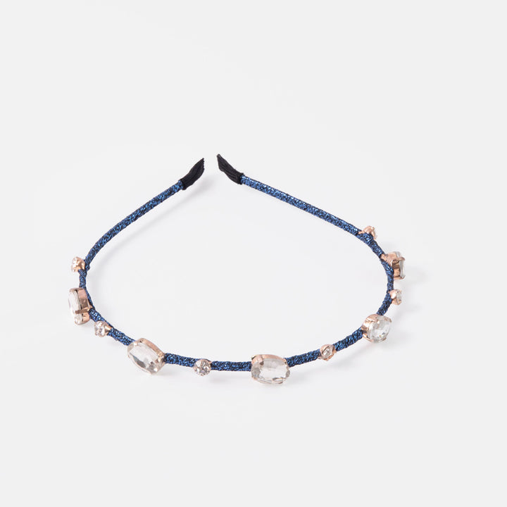 Navy blue headband with crystal-like beads on a white background