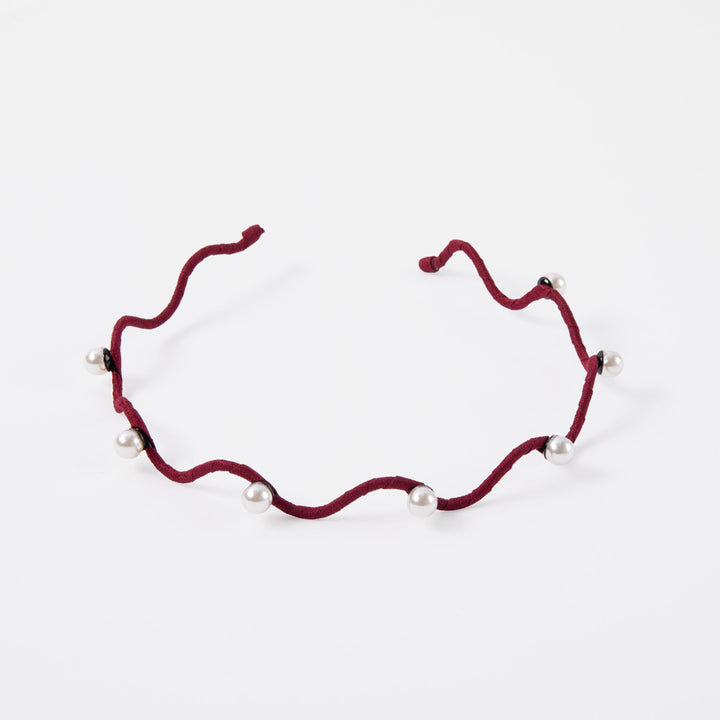 burgundy thin wavy headband set with pearls on a white background