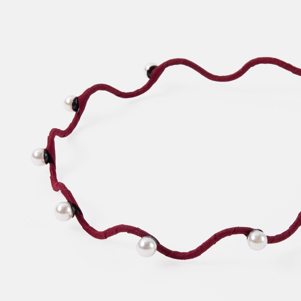 burgundy thin wavy headband set with pearls on a white background