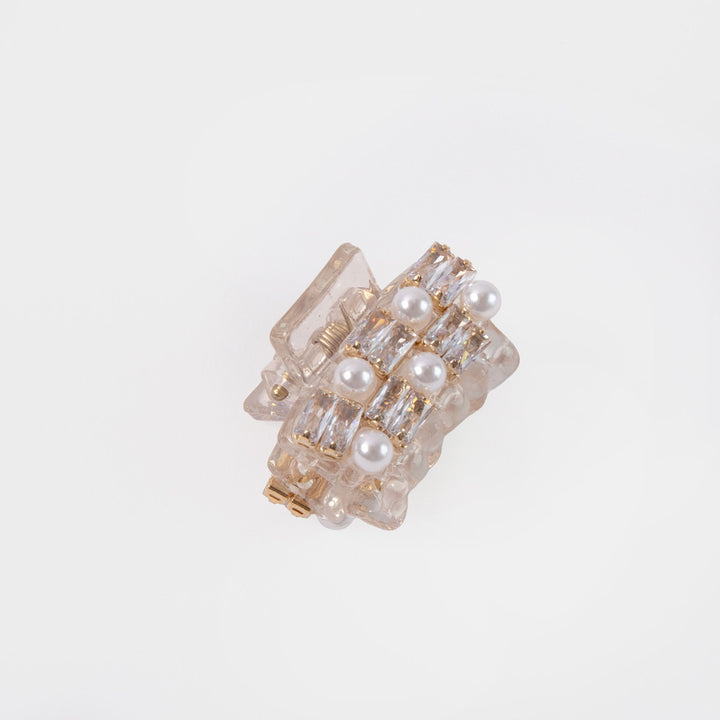 small hair claw encrusted with pearls and crystals on a white background 