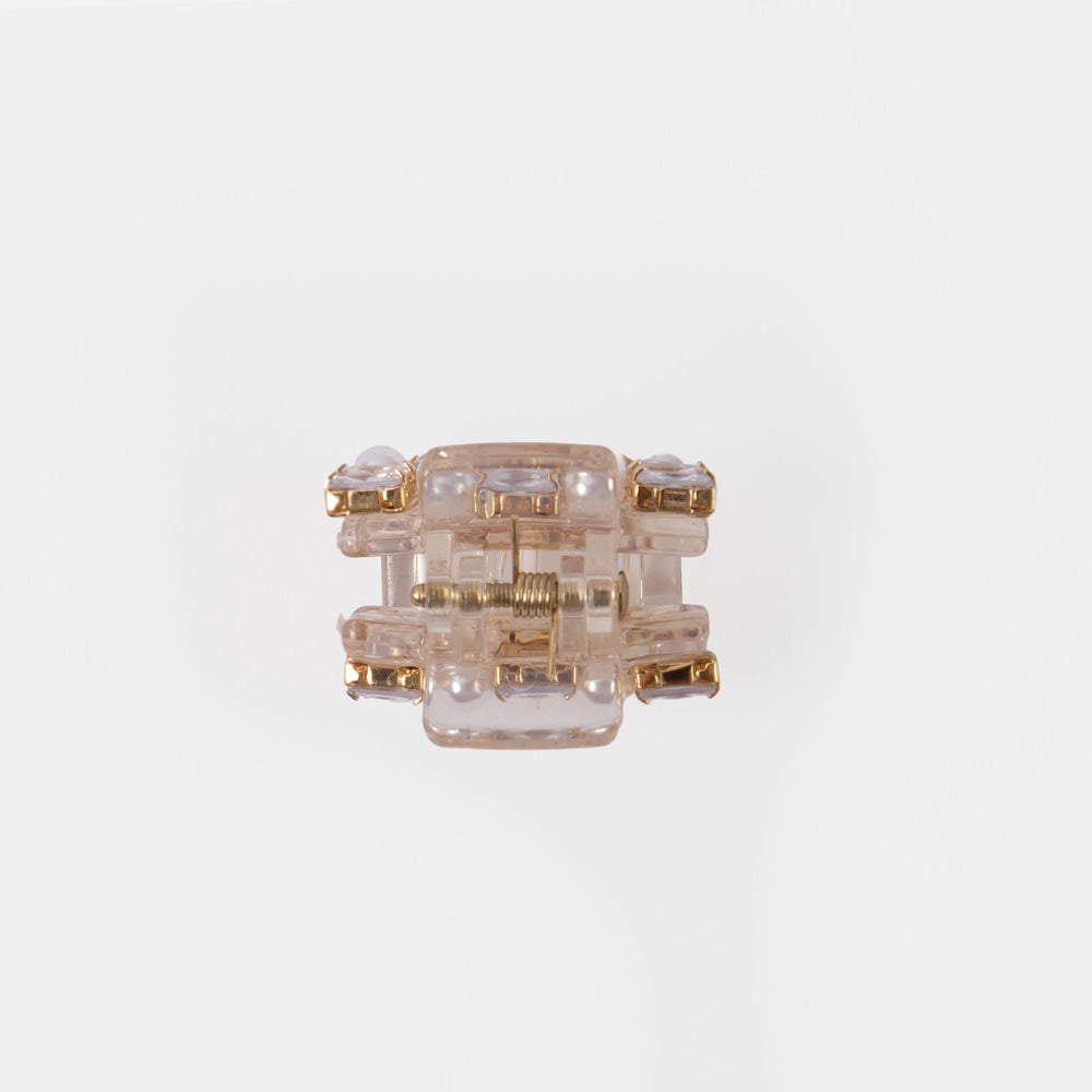 small hair claw encrusted with pearls and crystals on a white background 