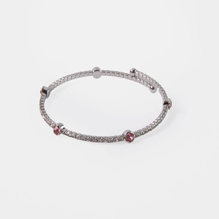 silver bangle set with small silver crystals and larger pink crystals 