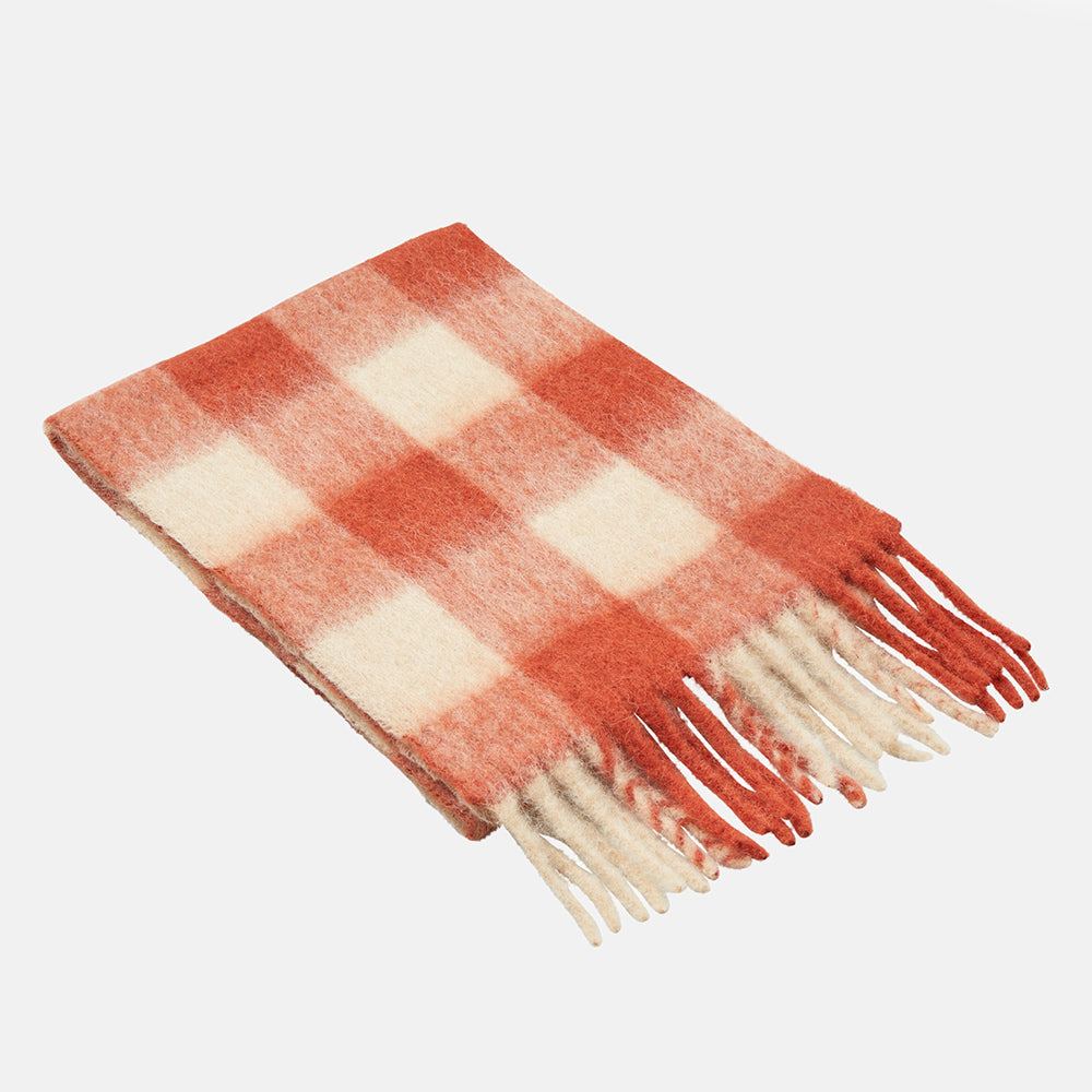 A folded orange and cream check scarf with a fluffy brushed texture and fringed ends, on a light grey background.