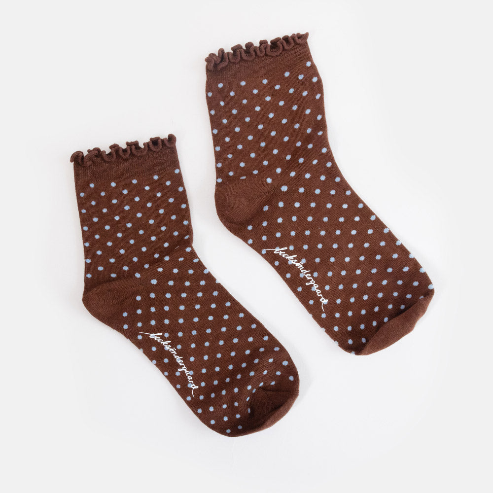 A single brown ankle sock with a scalloped ruffle edge and a pattern of small white and light blue polka dots, shown against a light gray background.