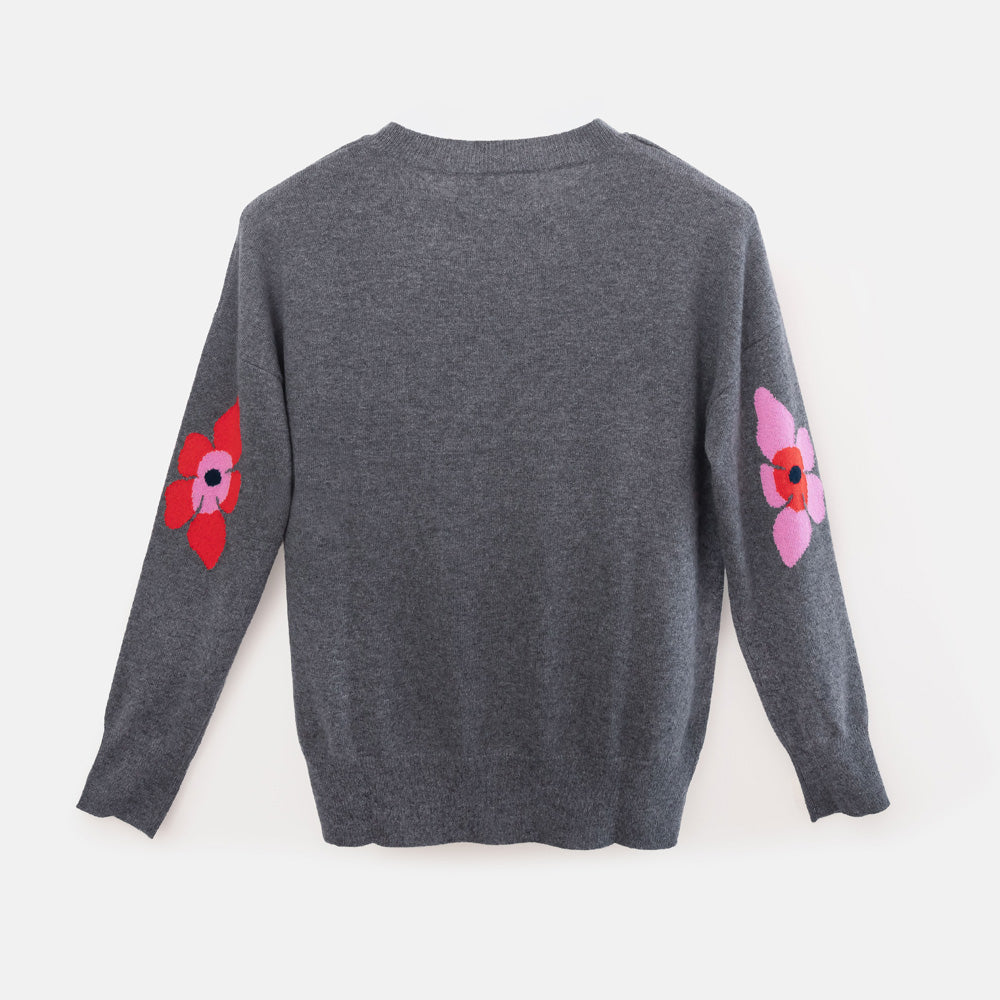 A dark gray long-sleeve knit sweater shown from the back, featuring two colorful floral patches on the sleeves.