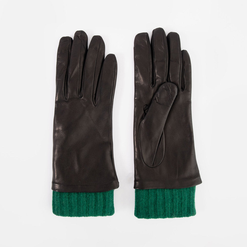 A pair of black leather gloves with a contrasting green ribbed knit cuff, displayed flat against a light gray background.