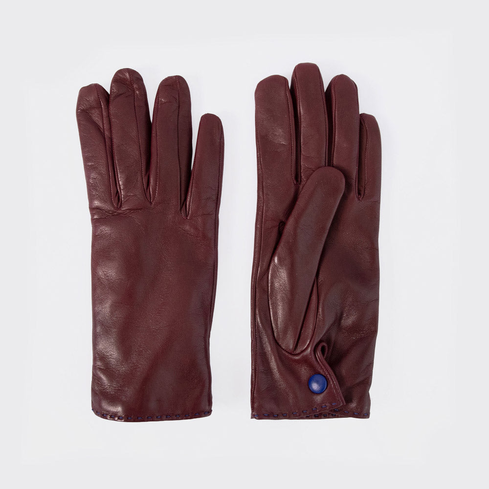 A pair of dark burgundy leather gloves laid flat on a light gray background, showing both the back of one glove and the front of the other with a small blue button detail.
