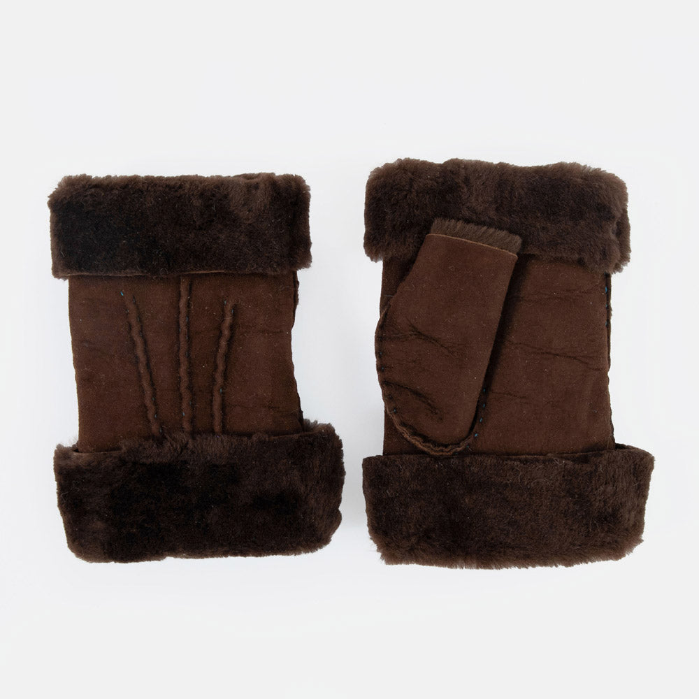 A pair of dark brown shearling wrist warmers with plush dark brown wool trim, displayed on a clean white background.