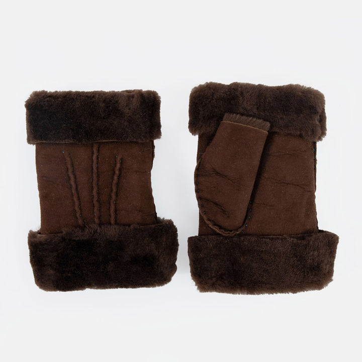 A pair of dark brown shearling wrist warmers with plush dark brown wool trim, displayed on a clean white background.