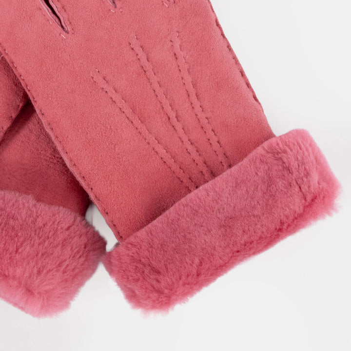 A close-up of a dusty pink suede glove with a soft, fuzzy pink faux-fur cuff, shown against a clean white background.