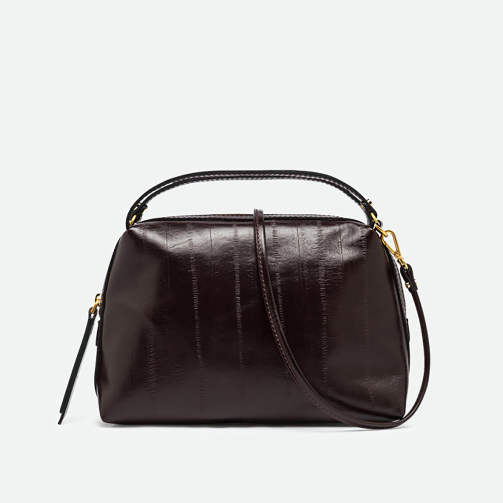 Dark burgundy glossy leather handbag with panelled texture, top handles and gold hardware