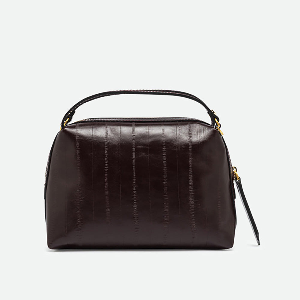 Front of a dark burgundy glossy leather handbag with two top handles
