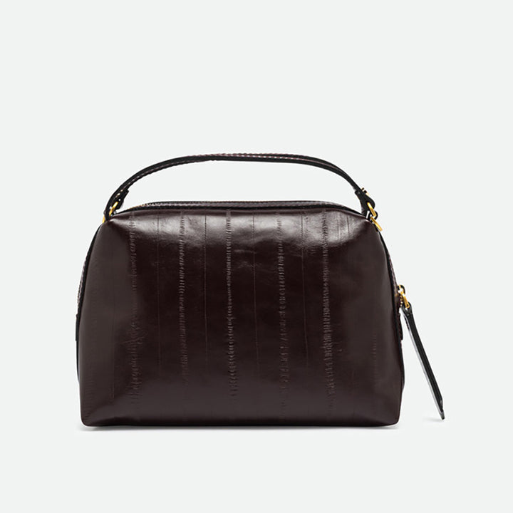 Front of a dark burgundy glossy leather handbag with two top handles