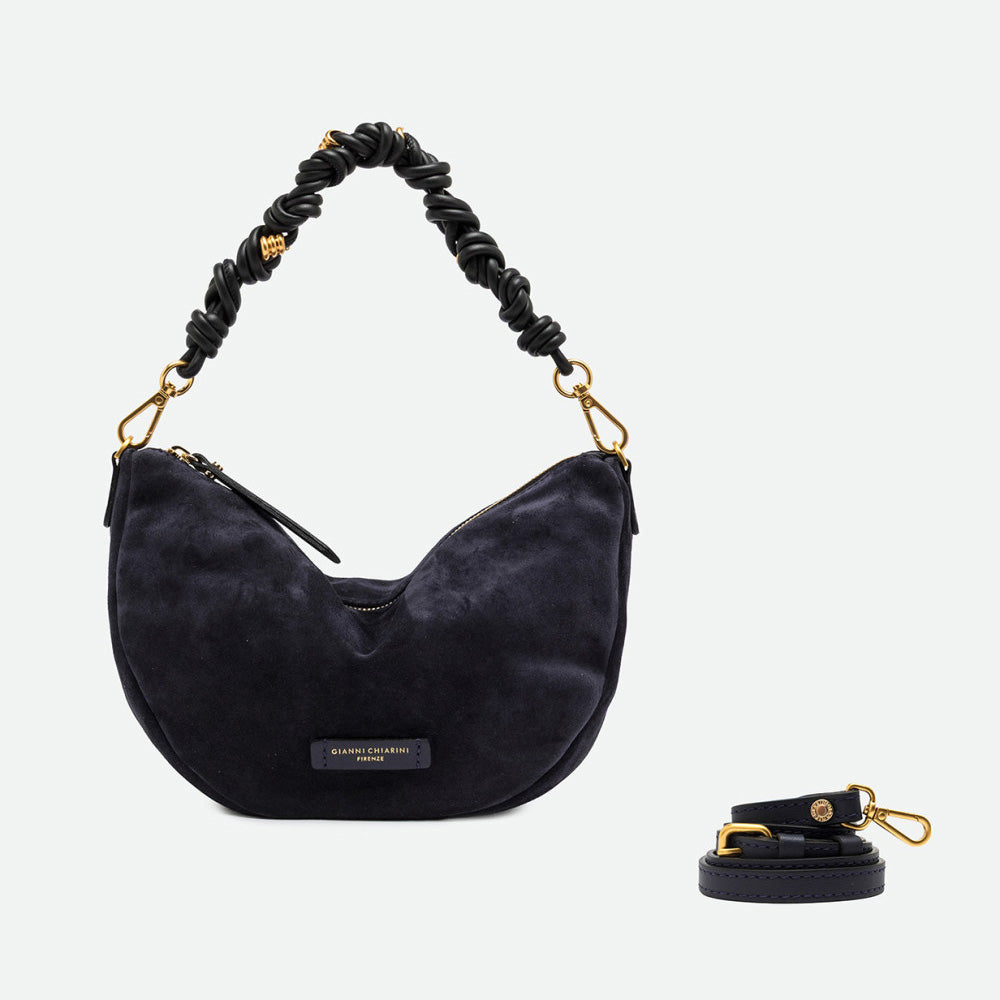Navy suede half moon bag shown beside a separate long crossbody strap