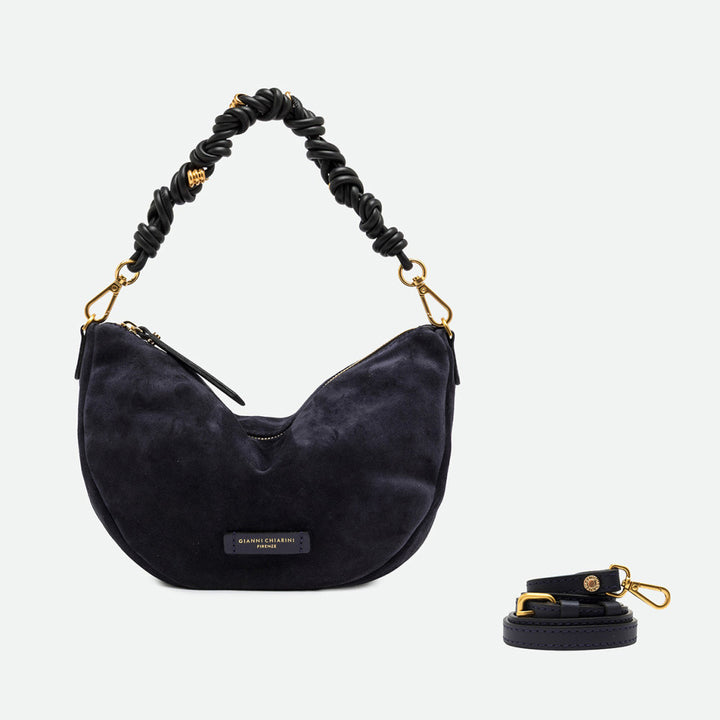 Navy suede half moon bag shown beside a separate long crossbody strap