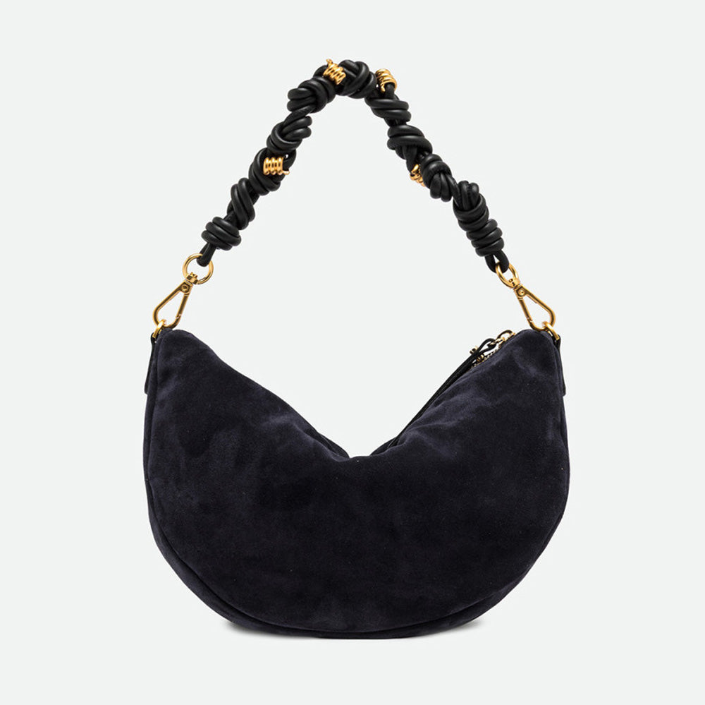 Back of a navy suede half moon shoulder bag with a ruched handle