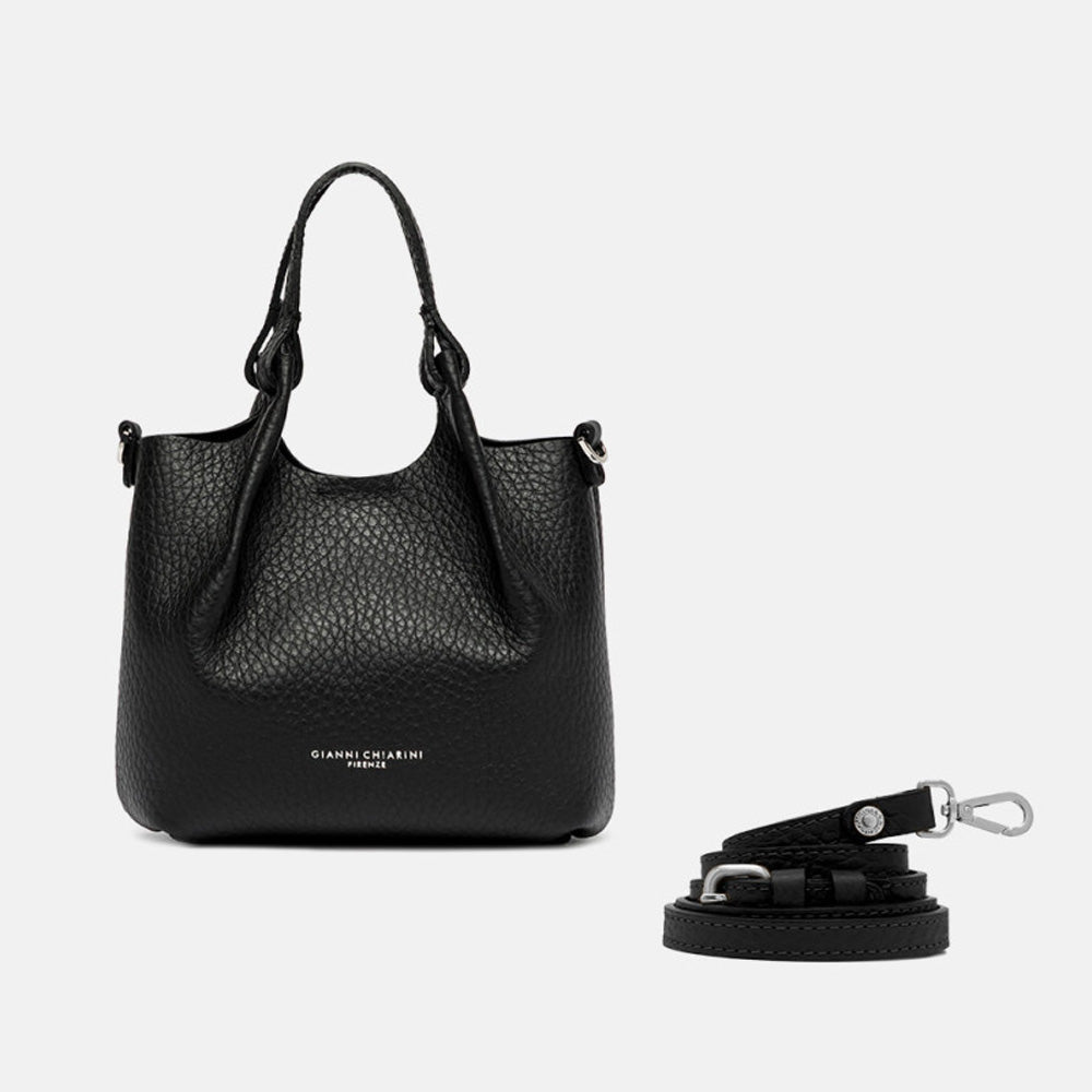 Small black leather tote with its sides opened out, beside a separate shoulder strap