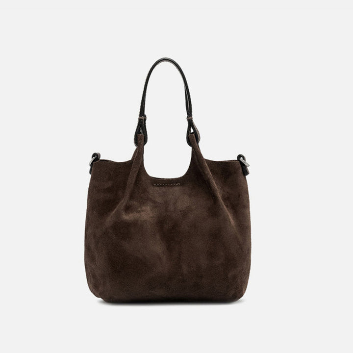 Front of a small dark brown suede tote with its sides opened out