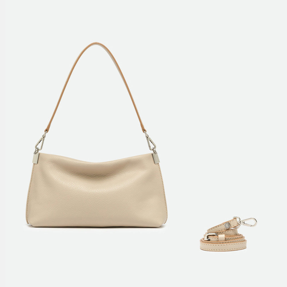 Slim cream leather shoulder bag shown beside a separate long crossbody strap