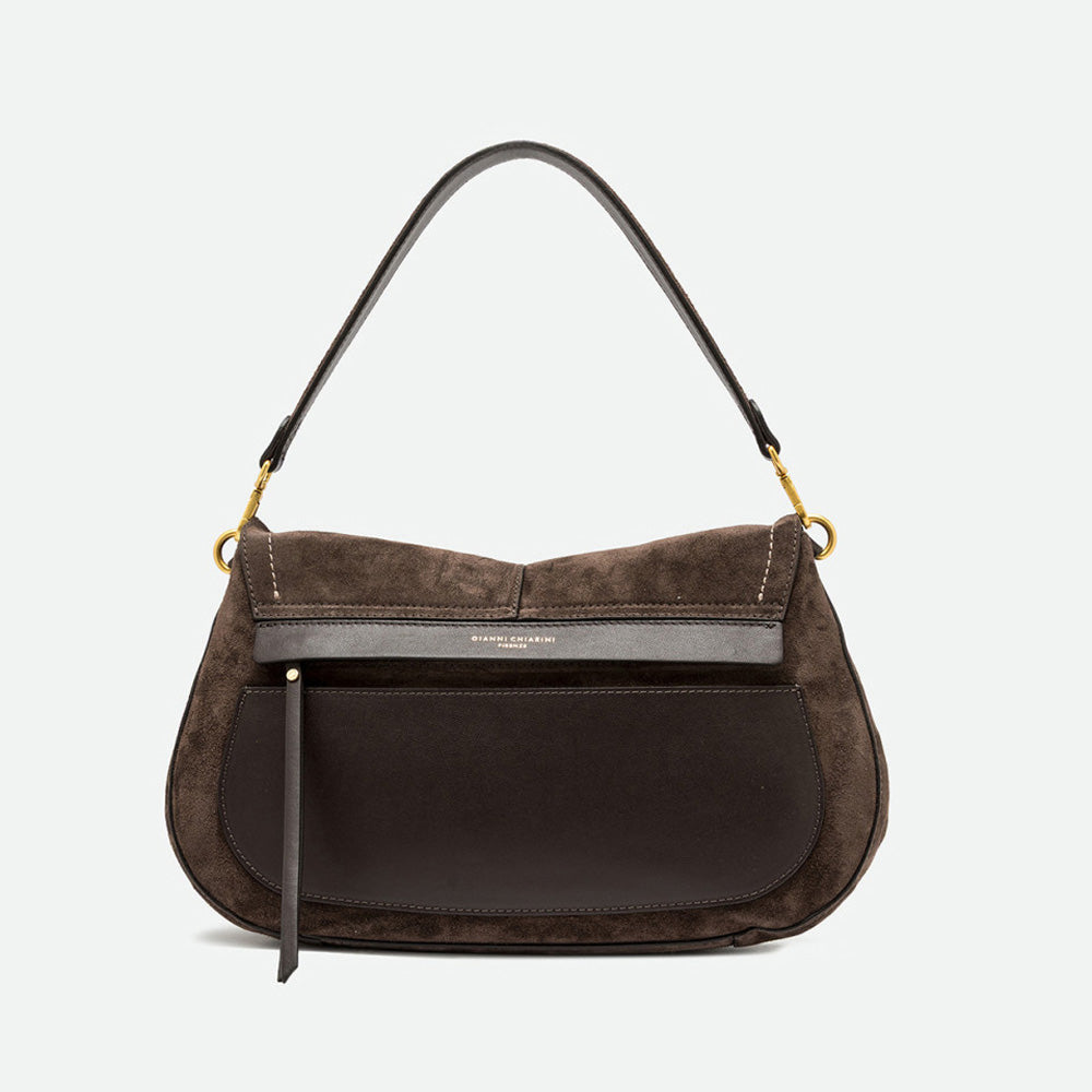 Back of a dark brown suede saddle bag showing a smooth leather panel and zip pocket