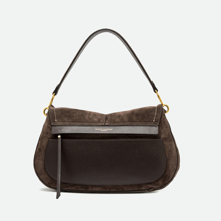 Back of a dark brown suede saddle bag showing a smooth leather panel and zip pocket