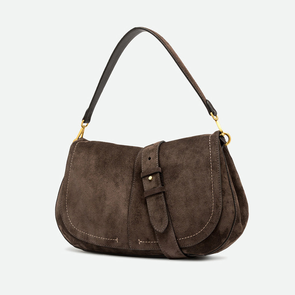 Angled view of a dark brown suede saddle bag with a buckled flap