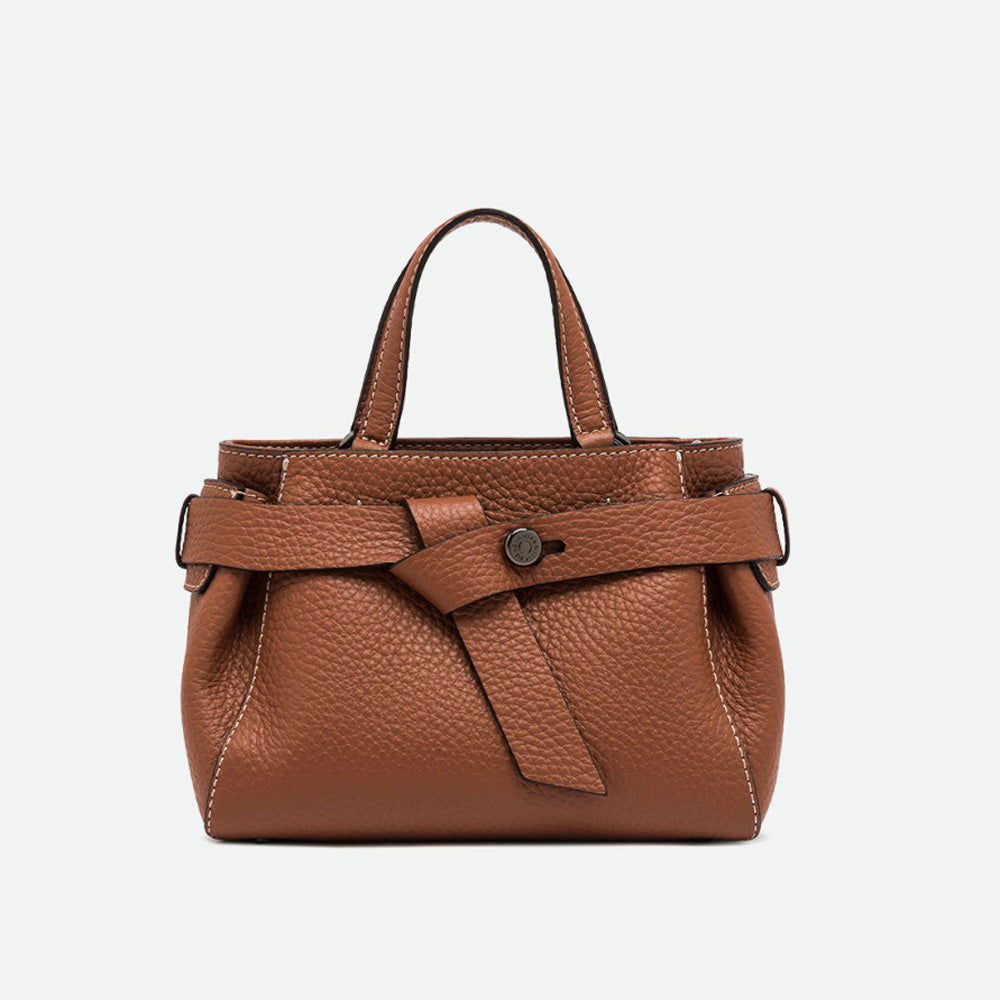 Structured tan pebbled leather top handle bag with a wrap-around belt detail