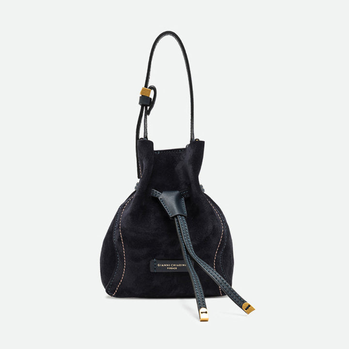 Small navy suede drawstring bucket bag with a leather shoulder strap and gold tips