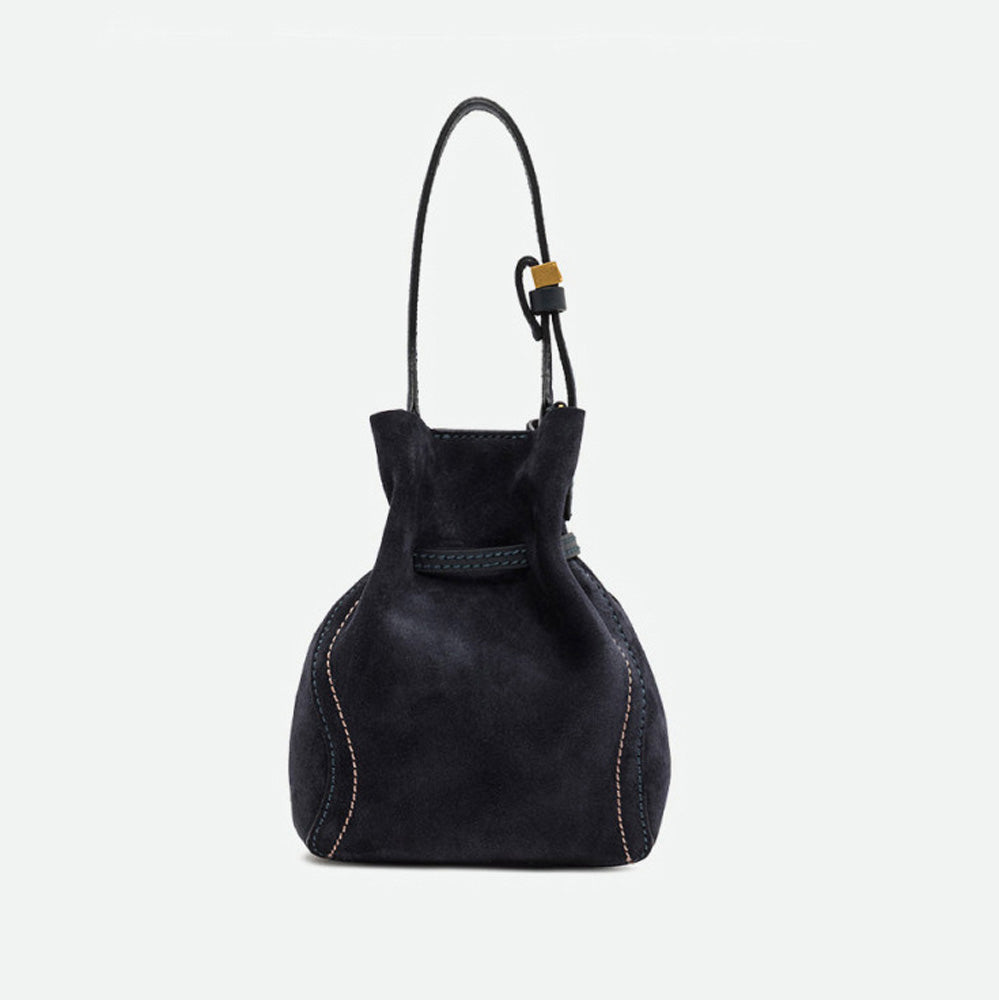 Back of a small navy suede drawstring bucket bag